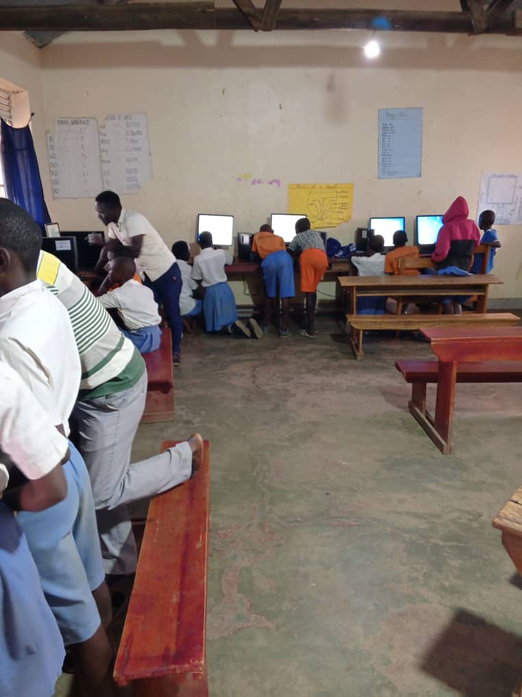 Primary school learners taking a computer class
